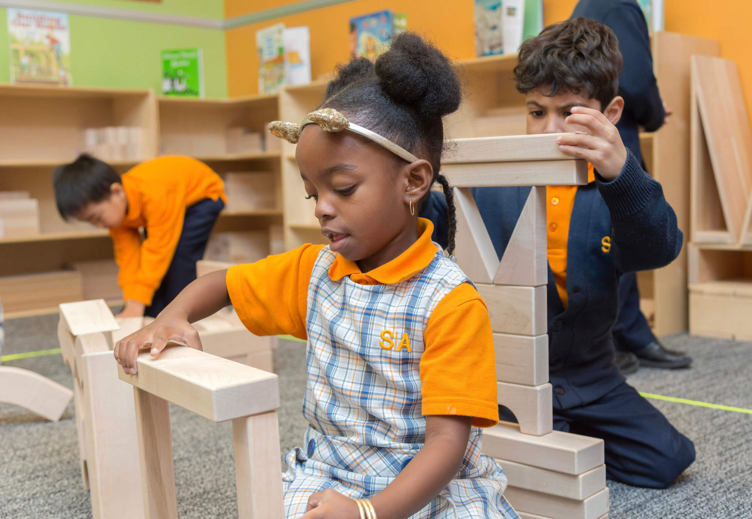 elementary students stacking wood blocks