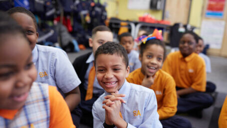 Students sitting in a group on the floor