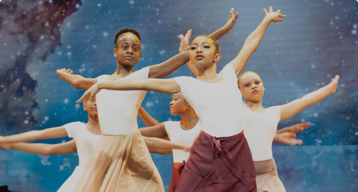 Group of students performing a dance routine on stage