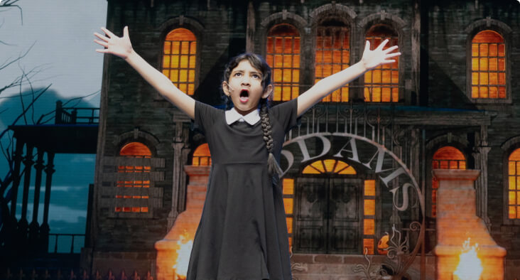 Student performing on stage in a theater production